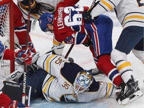 Canadiens forward Artturi Lehkonen falls over Buffalo Sabres goaltender Linus Ullmark during first period NHL action at the Bell Centre in Montreal on Nov. 8, 2018.