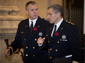 Sylvain Caron, nominated by the selection committee to become the new SPVM police chief, speaks with outgoing police chief Martin Prud'homme, right, as they arrive at city hall in Montreal on Friday November 9, 2018.