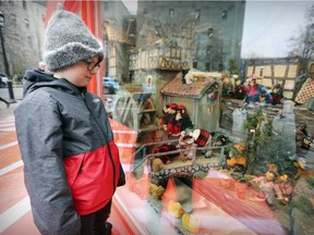 Lars Schougaard, 8, takes in The Mill in the Forest display outside the McCord Museum. The Enchanted Village, meanwhile, resides in a room on the second floor.