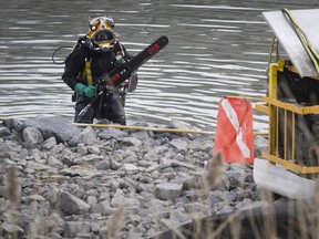 Commercial diver brings down underwater saw at site were underwater sewer line is being changed in the town of Longueuil on Thursday November 15, 2018.