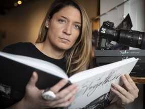 Wearing her Grey Cup ring, Johany Jutras goes through her book Together at her home on Thursday.