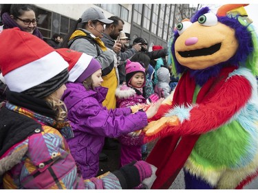 Kids and clowns take part in the Santa Claus Parade along Ste-Catherine St. in Montreal on Saturday, Nov. 17, 2018.