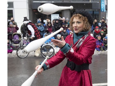 A juggler takes part in the Santa parade along Ste-Catherine in Montreal on Saturday, Nov. 17, 2018.