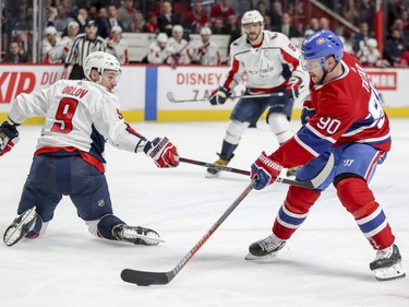 Washington Capitals' Dmitry Orlov reaches by to obstruct Montreal Canadiens' Tomas Tatar with Alex Ovechkin trailing the play during third period of National Hockey League game in Montreal Monday November 19, 2018.