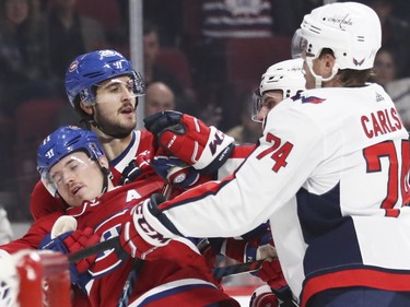 Brendan Gallagher gets shoved into teammate Philip Danault by Washington Capitals' John Carlson during first period at the Bell Centre on Monday, Nov. 19, 2018.