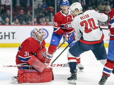 Carey Price squeezes the puck to his chest as Washington Capitals' Lars Eller looks for rebound during second period at the Bell Centre on Monday, Nov. 19, 2018.