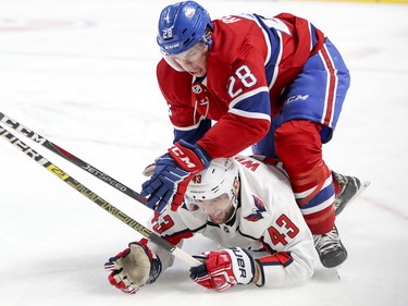 Mike Reilly drives Washington Capitals' Tom Wilson to the ice during second period at the Bell Centre on Monday, Nov. 19, 2018.