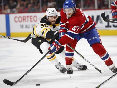 Boston Bruins' Sean Kuraly tries to slow down Canadiens' Kenny Agostino in Montreal on Saturday, Nov. 24, 2018.