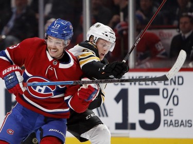 Canadiens' Max Domi and Boston Bruins' Colby Cave get tied up in Montreal on Saturday, Nov. 24, 2018.