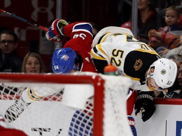 Canadiens' Charles Hudon upends Boston Bruins' Sean Kuraly in Montreal on Saturday, Nov. 24, 2018.