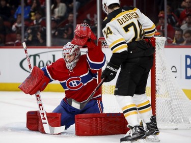 Boston Bruins' Jake DeBrusk watches as Canadiens goaltender Carey Price makes a glove save in Montreal on Saturday, Nov. 24, 2018.