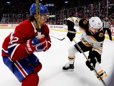 Canadiens' Jonathan Drouin keeps his eye on Boston Bruins' Sean Kuraly as he lines him up for a big hit in Montreal on Saturday, Nov. 24, 2018.
