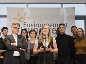 Catherine Gauthier, director general of Environnement Jeunesse, speaks with youth and lawyer Bruce Johnston (left), of firm Trudel Johnston & Lesperance  after announcing they intend to sue the Government of Canada on its inaction on climate change in Montreal, November 26, 2018.
