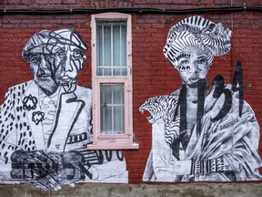 A mural by Montreal artist MissMe featuring images of Leonard Cohen and Marie-Joseph Angélique on the laneway wall of Lloydie's on St-Viateur St. W. in Montreal on Monday November 26, 2018.