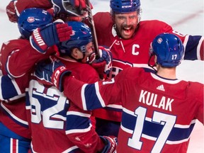 Canadiens captain Shea Weber celebrates Phillip Danault's third-period goal with teammates Tuesday night.