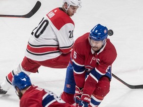 Carolina Hurricanes' Sebastian Aho looks on as the puck bounces past the head of Montreal Canadiens defenceman Shea Weber after blocking a shot at the Bell Centre on Nov. 27, 2018.