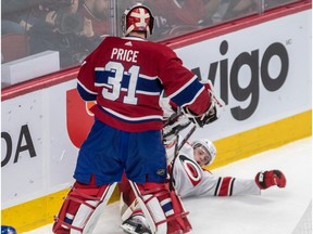 Canadiens goaltender Carey Price knocks Hurricanes winger Warren Foegele (to the ice during second period Tuesday night at the Bell Centre.