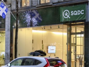 A video screen in the lobby of the SQDC outlet on Ste-Catherine St. displays facts about cannabis can clearly be seen through the window by passersby .