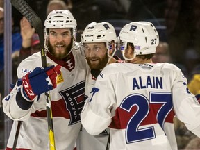 Laval Rocket defenseman Karl Alzner, centre, is congratulated by teammates Brett Lernout (14) and Alexandre Alain and (27) after Alzner scored his first Rocket goal of the season against the Belleville Senators during first- period AHL action at Place Bell in Laval, on Wednesday, Nov. 28, 2018.