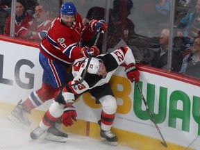 Montreal Canadiens' Shea Weber lifts his stick on New Jersey Devils' Stefan Noesen in Montreal on Dec. 14, 2017.
