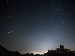 A Perseid meteor flashes across the night sky above Corfe Castle in the U.K. in August.