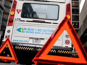 A broken-down STM bus blocks part of a Montreal street in 2017.