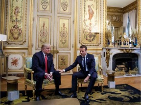 US President Donald Trump (L) speaks with French president Emmanuel Macron prior to their meeting at the Elysee Palace in Paris on November 10, 2018, on the sidelines of commemorations marking the 100th anniversary of the 11 November 1918 armistice, ending World War I.