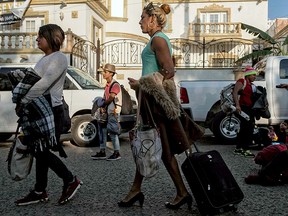 Members of the LGBTQ community — who split from a caravan of Central American migrants — arrive at the Diversidad Migrante NGO headquarters in Tijuana, Baja California state, Mexico, on November 11, 2018. -