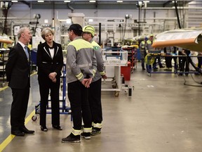 British Prime Minister Theresa May and the head of Bombardier's Belfast plant, Michael Ryan, speak to workers in February 2018.