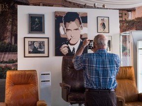 A visitor photographs a portrait of late Playboy publisher Hugh Hefner and other items displayed as part of Julien's Auctions upcoming sale of his belongings on November 26, 2018 in Beverly Hills, California.