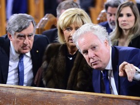 Former Quebec premier Lucien Bouchard (left to right) his wife Solange Dugas and former Quebec premier Jean Charest attend the funeral of former Quebec premier Bernard Landry at Notre-Dame Basilica in Montreal on Tuesday, Nov. 13, 2018.