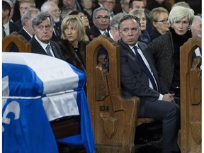 Quebec Premier François Legault and his wife, Isabelle Brais, and former Quebec premier Lucien Bouchard and his wife, Solange Dugas, attend funeral services for former Quebec premier Bernard Landry in Montreal on Tuesday, Nov. 13, 2018.