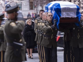 Chantal Renaud, wife of former Quebec Premier Bernard Landry, follows the casket of her husband into the Notre Dame Basilica for a day of visitation in Montreal on Monday, November 12, 2018.