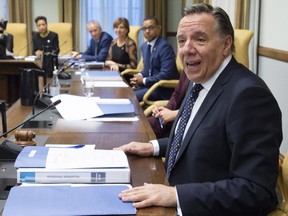 Quebec Premier François Legault, right, presides over his first cabinet meeting, Thursday, October 18, 2018 at his office at the legislature in Quebec City.