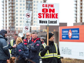 Canada Post workers walk the picket line as a rotating strike continues in Halifax on Tuesday, Nov. 13, 2018.
