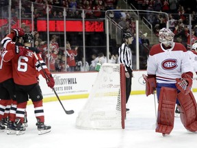 New Jersey Devils celebrate a goal by centre Pavel Zacha as Montreal Canadiens goaltender Carey Price skates away during the second period on Nov. 21, 2018, in Newark, N.J.