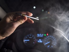 In this photo illustration, smoke from a cannabis oil vaporizer is seen as the driver is behind the wheel of a car in North Vancouver, B.C. Wednesday, Nov. 14, 2018. Canadian police have not seen a spike in cannabis-impaired driving one month since legalization, but there needs to be more awareness of laws around storing marijuana in vehicles and passengers smoking weed, law enforcement officials say.