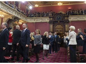Successful Coalition Avenir Quebec candidates are applauded as they enter to be sworn in as members of the National Assembly Tuesday, October 16, 2018 at the legislature in Quebec City. As the new government gets organized, it is turning to many ex-Péquistes to fill key staff positions, Don Macpherson writes.