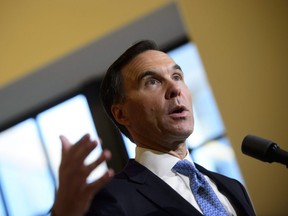 Finance Minister Bill Morneau holds a press conference in the media lockup for the fall economic update, in Ottawa on Wednesday, Nov. 21, 2018.