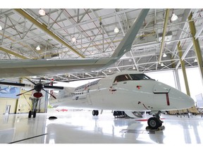 A Bombardier Q400 jet sits in a hangar at the Bombardier facility in Toronto, Ontario on Wednesday July 25, 2012. The head of the British Columbia aviation company that scooped up Bombardier Inc.'s Q400 turboprop business is pledging to keep all manufacturing already in Canada within the country.