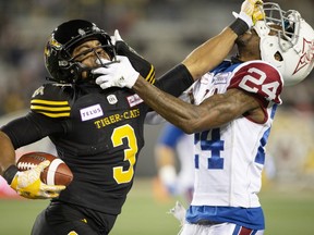 Hamilton Tiger-Cats wide receiver Marquay McDaniel (3) and Montreal Alouettes defensive back T. J. Heath commit off-setting face-mask infractions Hamilton on Saturday, Nov. 3, 2018.