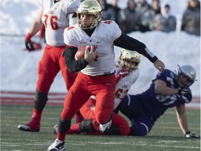 Laval University Rouge et Or's quarterback Hugo Richard runs to a first down against Western University Mustangs at the Vanier Cup final Saturday, Nov. 24, 2018, in Quebec City.