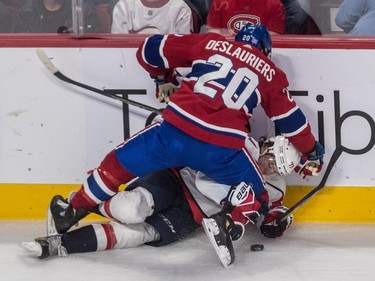 Nicolas Deslauriers gives Washington Capitals right wing T.J. Oshie a rough ride along the boards during second-period action at the Bell Centre on Thursday, Nov. 1, 2018.