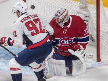 Washington Capitals centre Evgeny Kuznetsov and Carey Price can't find the puck during a scramble in front of the net in first period at the Bell Centre on Thursday, Nov. 1, 2018.