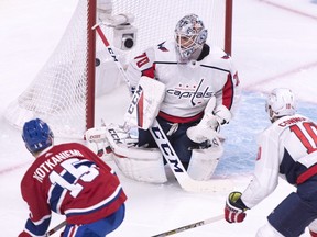 Jesperi Kotkaniemi scores on Washington Capitals goaltender Braden Holtby as Capitals' Brett Connolly looks on during first-period action in Montreal on Thursday, Nov. 1, 2018.