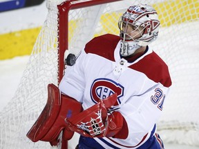 Canadiens' Carey Price grabs puck during second period Thursday in Calgary, one of 43 saves he made on the night.