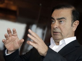 In this Friday, April 20, 2018 photo, Nissan Chairman Carlos Ghosn speaks during an interview in Hong Kong. Ghosn, who became one of the auto industry's most powerful executives by engineering a turnaround at the Japanese manufacturer, was arrested Monday and will be fired for allegedly underreporting his income and misusing company funds, the automaker said.