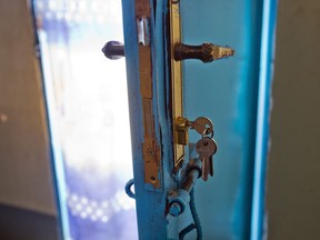 A set of keys hangs from a door lock.