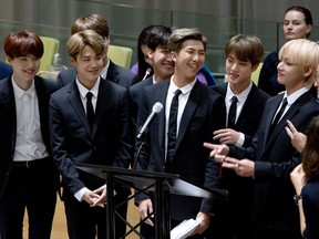 FILE - In this Sept. 24, 2018, file photo, members of the Korean K-Pop group BTS attend a meeting at the U.N. high level event regarding youth during the 73rd session of the United Nations General Assembly, at U.N. headquarters. A Japanese broadcaster canceled a live TV appearance of the Korean band BTS after a photo went viral of a band member wearing a T-shirt showing an atomic bombing juxtaposed with the celebration of Korea's liberation from Japan after World War II.