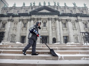 Claude shovels snow from the steps of Mary Queen of the World Cathedral in Montreal Nov. 16, 2018.
